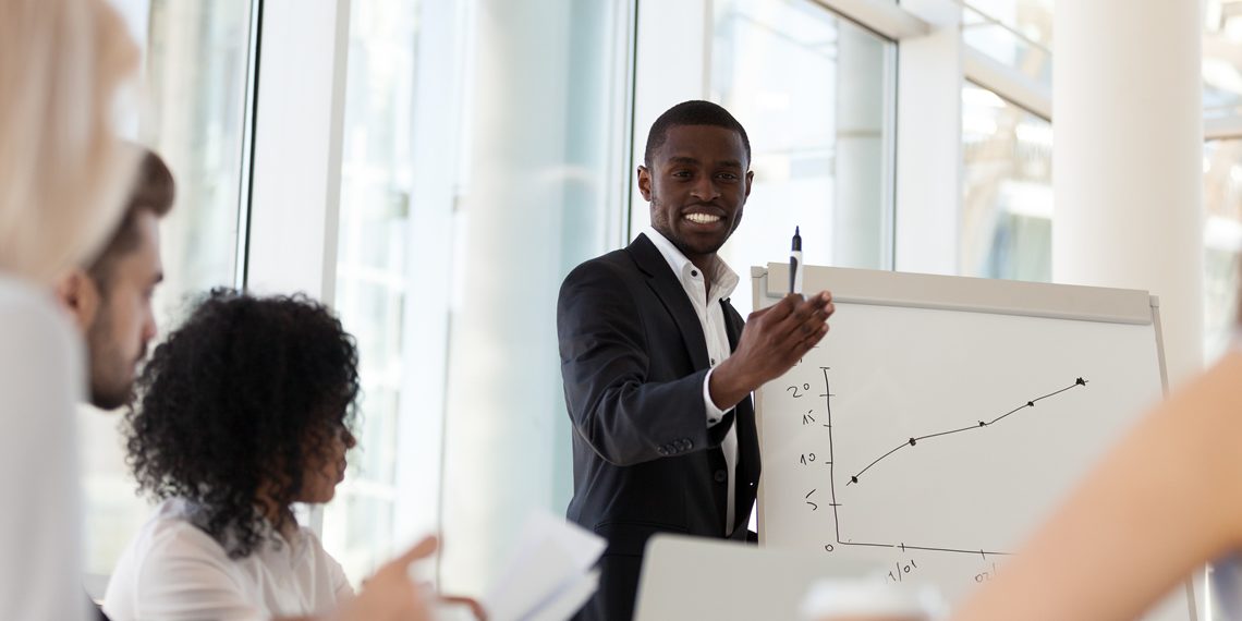 Millennial leader making presentation to team in board room