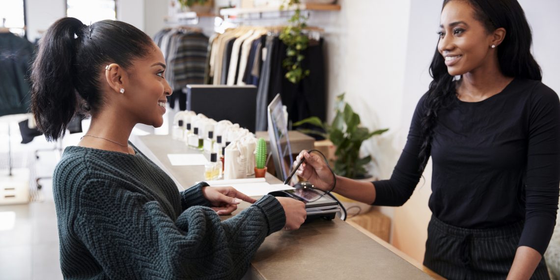 smiling business owner serving customer