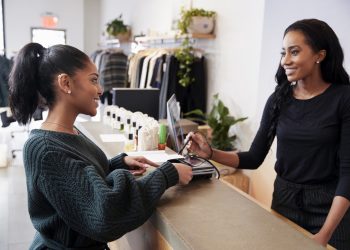 smiling business owner serving customer