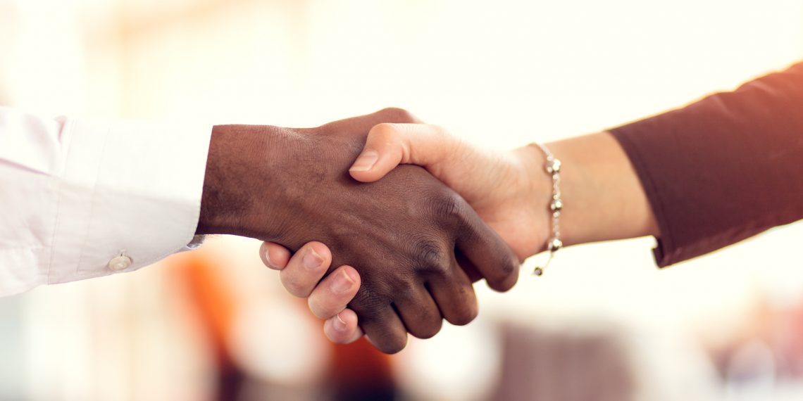 close up of man and woman shaking hands