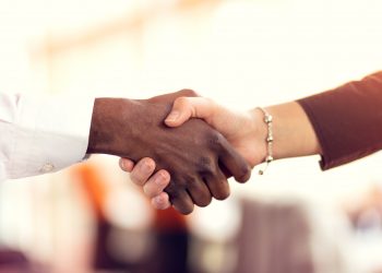 close up of man and woman shaking hands
