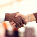 close up of man and woman shaking hands