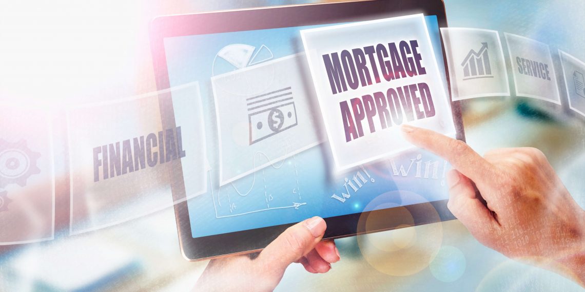 A businesswoman selecting a Mortgage Approved business concept on a futuristic portable computer screen