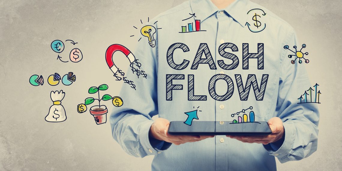 business owner holding ipad with cash flow icons floating