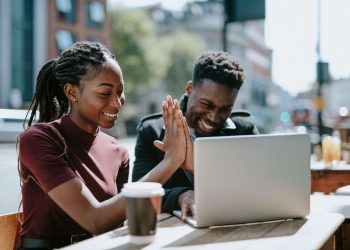two young business owners give high five after they set up business
