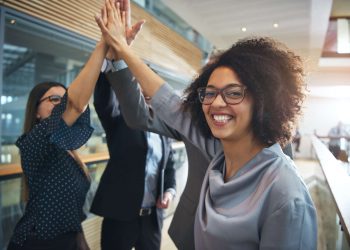 employees give high five in office