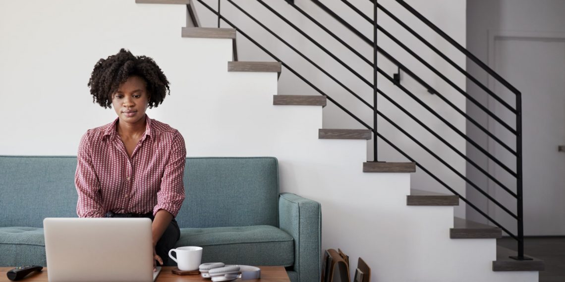 young business woman sitting on sofa planning her insurance